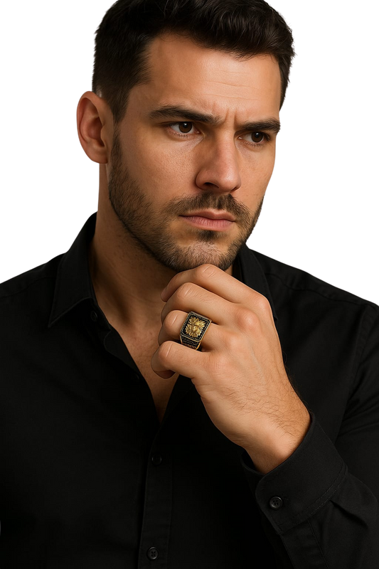 Man wearing a black shirt with a gold ring on his finger against a white background